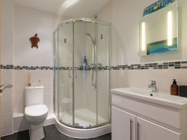 A bathroom with a shower, toilet, and sink at Anchors Rest in St. Ives