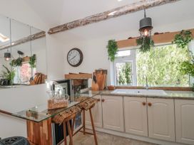 A kitchen with a sink, countertop, and clock at 7 The Cedars, Wotton-Under-Edge
