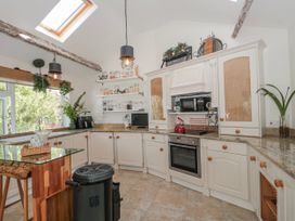 A kitchen with cabinets and appliances at 7 The Cedars in Wotton-Under-Edge