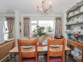 A dining room with a table and chairs at 7 The Cedars in Wotton-Under-Edge
