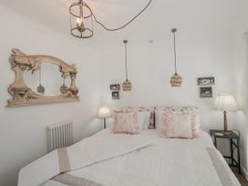 A bedroom with a bed and lamp at 7 The Cedars in Wotton-Under-Edge