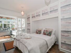 A bedroom with a bed and wall cabinetry at 7 The Cedars in Wotton-Under-Edge