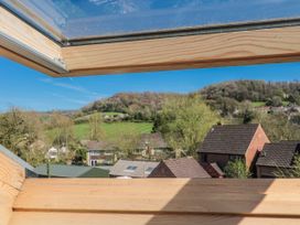 A view from a roof window overlooking hills and houses at 7 The Cedars Wotton-Under-Edge