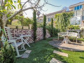 A garden with a chair and bench at 7 The Cedars in Wotton-Under-Edge