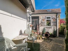 A garden with gravel path and seating area at 7 The Cedars Wotton-Under-Edge