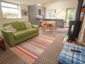A living room with a sofa and dining area at Millmead House Annex Portesham