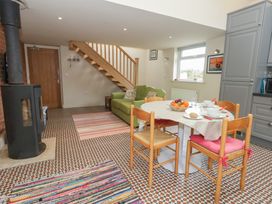 A living room with a dining table and sofa at Millmead House Annex Portesham
