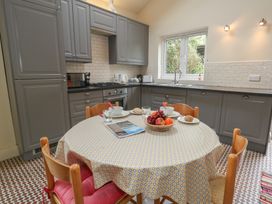 A kitchen with a table and chairs at Millmead House Annex in Portesham