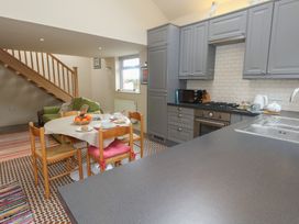 A kitchen with a dining area and staircase at Millmead House Annex Portesham