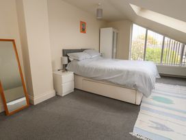 A bedroom with a bed and wardrobe at Millmead House Annex Portesham
