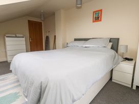 A bedroom with a bed and furniture at Millmead House Annex Portesham