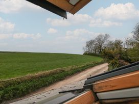 A view of a green field and a rural road at Millmead House Annex Portesham