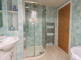 A bathroom with a shower, sink, and towel rack at Millmead House Annex Portesham