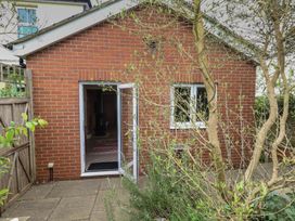 An outdoor view of a brick structure with plants around at Millmead House Annex Portesham