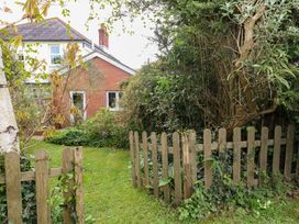 A garden with a wooden fence and plants at Millmead House Annex Portesham