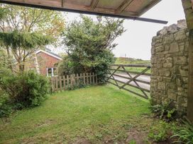 A garden with grass and a wooden gate at Millmead House Annex Portesham