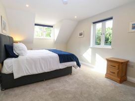 A bedroom with a bed and nightstand at Bramley Cottage in Worlingham