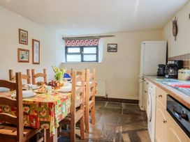 A kitchen with a dining table and chairs at Cider House in Hawkchurch