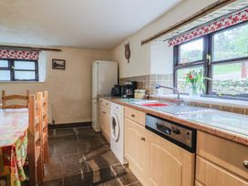 A kitchen with a sink and refrigerator at Cider House in Hawkchurch
