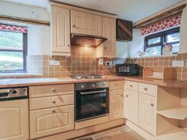 A kitchen with cabinets and appliances at Cider House in Hawkchurch