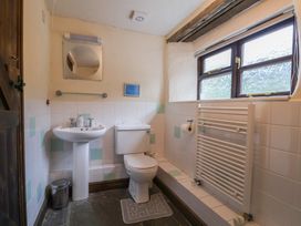 A bathroom with a sink and toilet at Cider House in Hawkchurch