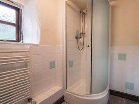 A bathroom with shower and radiator at Cider House in Hawkchurch