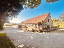 A house with a stone exterior and a sloped roof at Cider House in Hawkchurch