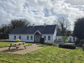A house with a picnic table and garden at An Grianan Getaway in Burt