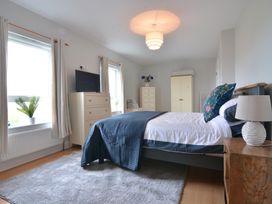 A bedroom with a bed and dresser at An Grianan Getaway, Burt