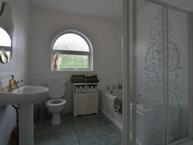 A bathroom with a shower and bathtub at An Grianan Getaway in Burt