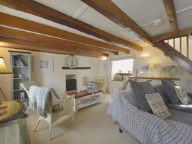 A living room with a sofa and armchairs at Mays Cottage Wadebridge