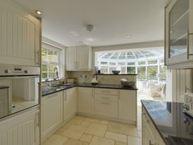 A kitchen with a sink and oven at Mays Cottage in Wadebridge
