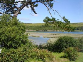 A scenic view of water and vegetation at Mays Cottage in Wadebridge