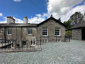 A house exterior with windows and gravel area at Kirkstone Brow in Ambleside