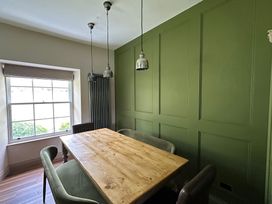 A dining room with a wooden table and chairs at Kirkstone Brow in Ambleside
