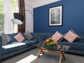 A living room with a sofa and coffee table at Apartment 2 in Torquay