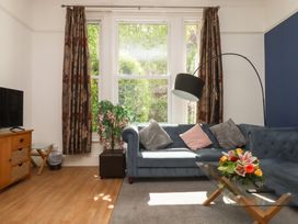 A living room with a sofa and television at Apartment 2 in Torquay