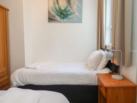 A bedroom with two beds and a lamp at Apartment 2 in Torquay