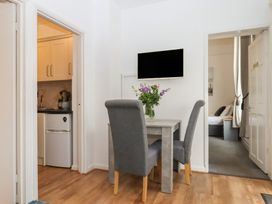 A dining room with a table and chairs at Apartment 4 in Torquay