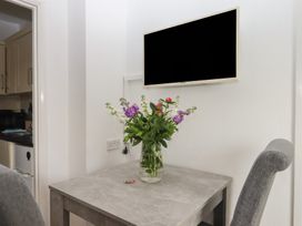 A dining room with a table and flowers at Apartment 4 in Torquay