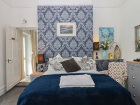 A bedroom with a bed and decorative items at Apartment 4, Torquay