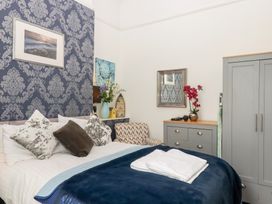 A bedroom with a bed and decorative items at Apartment 4 in Torquay