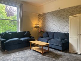 A living room with two sofas and a coffee table at Apartment 5 in Torquay