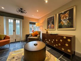 A living room with a sofa and sideboard at La'al Kirkstone Brow in Ambleside