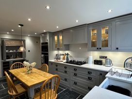 A kitchen with a table and chairs at La'al Kirkstone Brow in Ambleside
