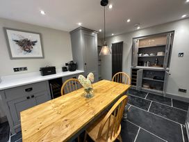 A kitchen with a wooden table and chairs at La'al Kirkstone Brow in Ambleside