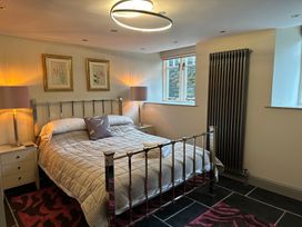 A bedroom with a bed and nightstands at La'al Kirkstone Brow in Ambleside