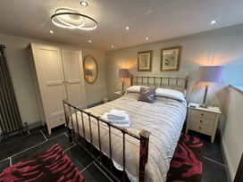 A bedroom with a bed and wardrobe at La'al Kirkstone Brow in Ambleside
