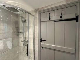 A bathroom with a shower and a sliding door at La'al Kirkstone Brow in Ambleside