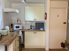 A kitchen with a sink and microwave at Apartment 9 in Torquay